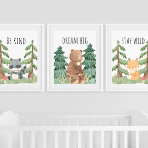 May include: Three watercolor prints with woodland animals and inspirational messages. The first print features a raccoon and says "Be Kind". The second print features a bear and says "Dream Big". The third print features a fox and says "Stay Wild".
