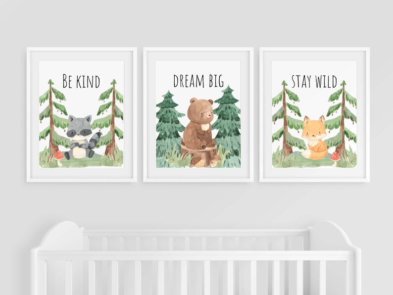 May include: Three watercolor prints with woodland animals and inspirational messages. The first print features a raccoon and says "Be Kind". The second print features a bear and says "Dream Big". The third print features a fox and says "Stay Wild".