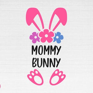 May include: Pink bunny ears with three flowers in pink, purple, and blue. The text "Mommy Bunny" is below the flowers.