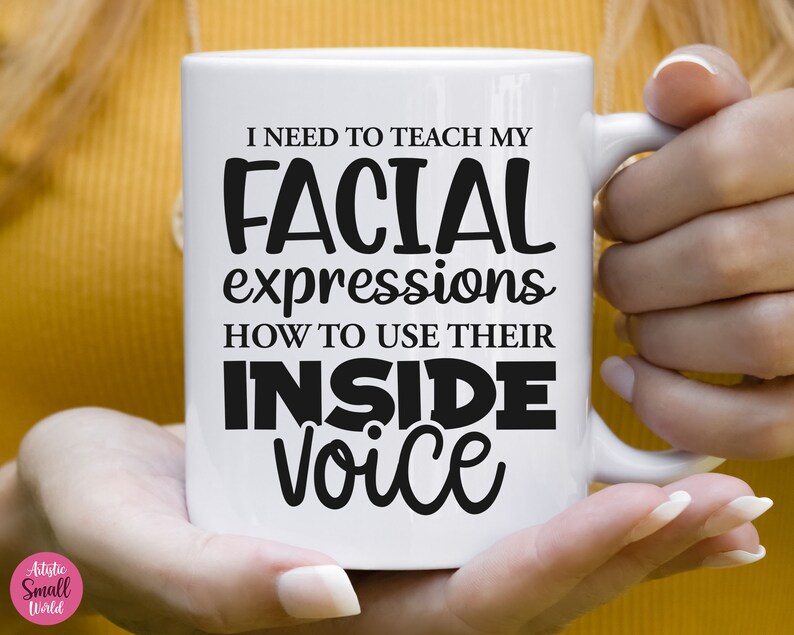 May include: White ceramic mug with black text that reads "I need to teach my facial expressions how to use their inside voice".