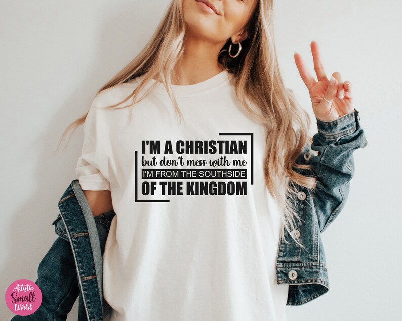 May include: White t-shirt with black text that reads "I'm a Christian but don't mess with me I'm from the Southside of the Kingdom."