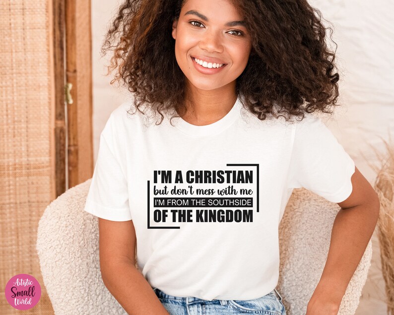 May include: White t-shirt with a black graphic that reads "I'M A CHRISTIAN but don't mess with me I'M FROM THE SOUTHSIDE OF THE KINGDOM"
