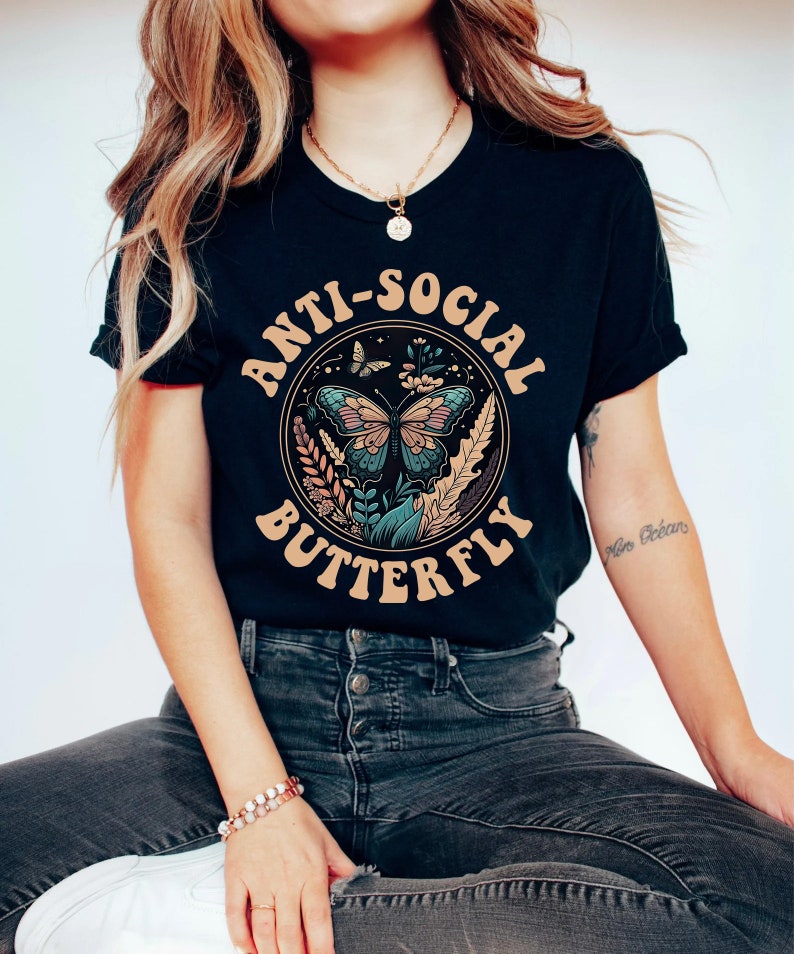 May include: Black t-shirt with a graphic of a butterfly in a circle with the text "Anti-Social Butterfly".