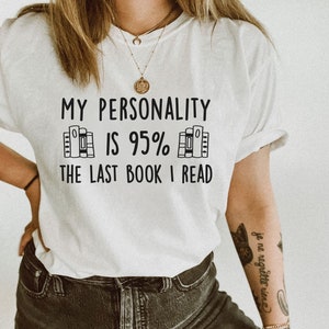 May include: White t-shirt with black text that reads "My personality is 95% the last book I read". The text is surrounded by a graphic of stacked books.