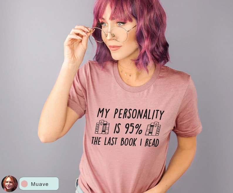 May include: A mauve t-shirt with the text "My personality is 95% the last book I read" in black. The text is surrounded by a graphic of stacked books.
