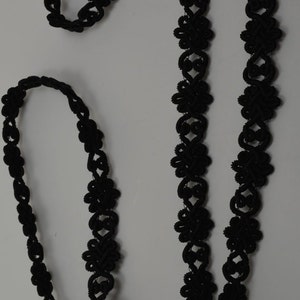 May include: Black lace trim with a floral design. The trim is made of a soft, flexible material and is perfect for adding a touch of elegance to any project.