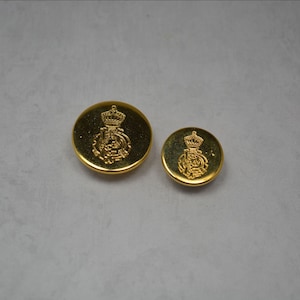 May include: Two gold-colored buttons with a crown and a crest design. The larger button is about 1 inch in diameter, and the smaller button is about 3/4 inch in diameter.