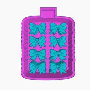 May include: A purple rectangular mold with a ridged border, containing eight teal bow shapes. The mold has a handle at the top. Ideal for crafting or baking decorative elements.