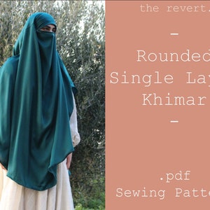 May include: A teal blue single layer khimar sewing pattern. The pattern is for a rounded khimar with a face covering. The text on the pattern reads "the revert. Rounded Single Layer Khimar .pdf Sewing Pattern".