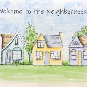May include: A watercolour illustration featuring a row of houses with the text "Welcome to the Neighbourhood!". The houses are in pastel colours, set against a green lawn and a blue sky. The houses have varied architectural styles.
