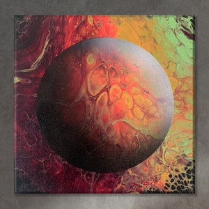May include: Abstract painting on canvas featuring a large, round, gray orb with a textured surface. The orb is surrounded by swirling, vibrant colors, including red, orange, yellow, and green.