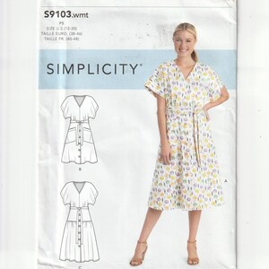 May include: A Simplicity sewing pattern envelope S9103 featuring a white dress with a colorful floral print, short sleeves, a V-neckline, and a tie waist. The pattern includes technical line drawings for variations B and C on the left side.