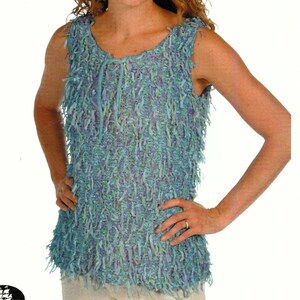 May include: A sleeveless top featuring a textured, shaggy fringe design in various shades of blue, teal, and purple. The garment has a round neckline with a decorative tie detail at the center front, creating a layered, multi-dimensional appearance.