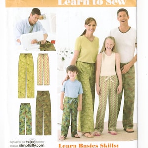 May include: A sewing pattern envelope titled Learn to Sew featuring illustrations and photographs of lounge pants with drawstring waistbands. The designs include various green patterns with leaf and lizard motifs, shown on a family of four models.