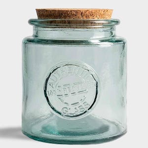 May include: A clear, cylindrical glass jar with a cork lid. The jar has a slightly blue-green tint and features a circular embossed design that reads "AUTHENTIC 100% RECYCLED GLASS". The jar is suitable for storage and decorative purposes.