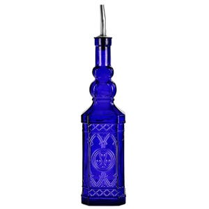 May include: A cobalt blue glass bottle with a decorative design and a stainless steel spout. The bottle has an ornate, vintage-inspired shape with geometric and floral patterns. It is designed for dispensing liquids.