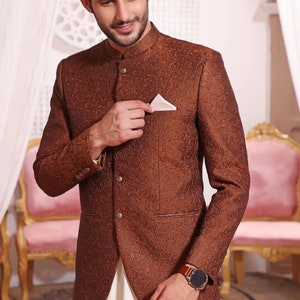 May include: A brown patterned blazer with a mandarin collar and a white pocket square. The blazer has a button closure and a single button on each cuff.
