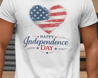 May include: A white short-sleeved t-shirt featuring a distressed heart-shaped graphic with the American flag pattern. Below the heart, the text reads Happy Independence DAY in blue and red lettering, accented with small blue and red stars.