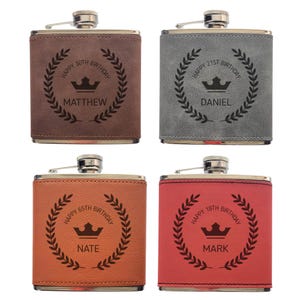 May include: Four personalised hip flasks in brown, grey, orange, and red. Each flask has a silver cap and is engraved with a birthday message, a crown, and a name. The messages include "Happy 30th Birthday Matthew", "Happy 21st Birthday Daniel", "Happy 65th Birthday Nate", and "Happy 18th Birthday Mark".