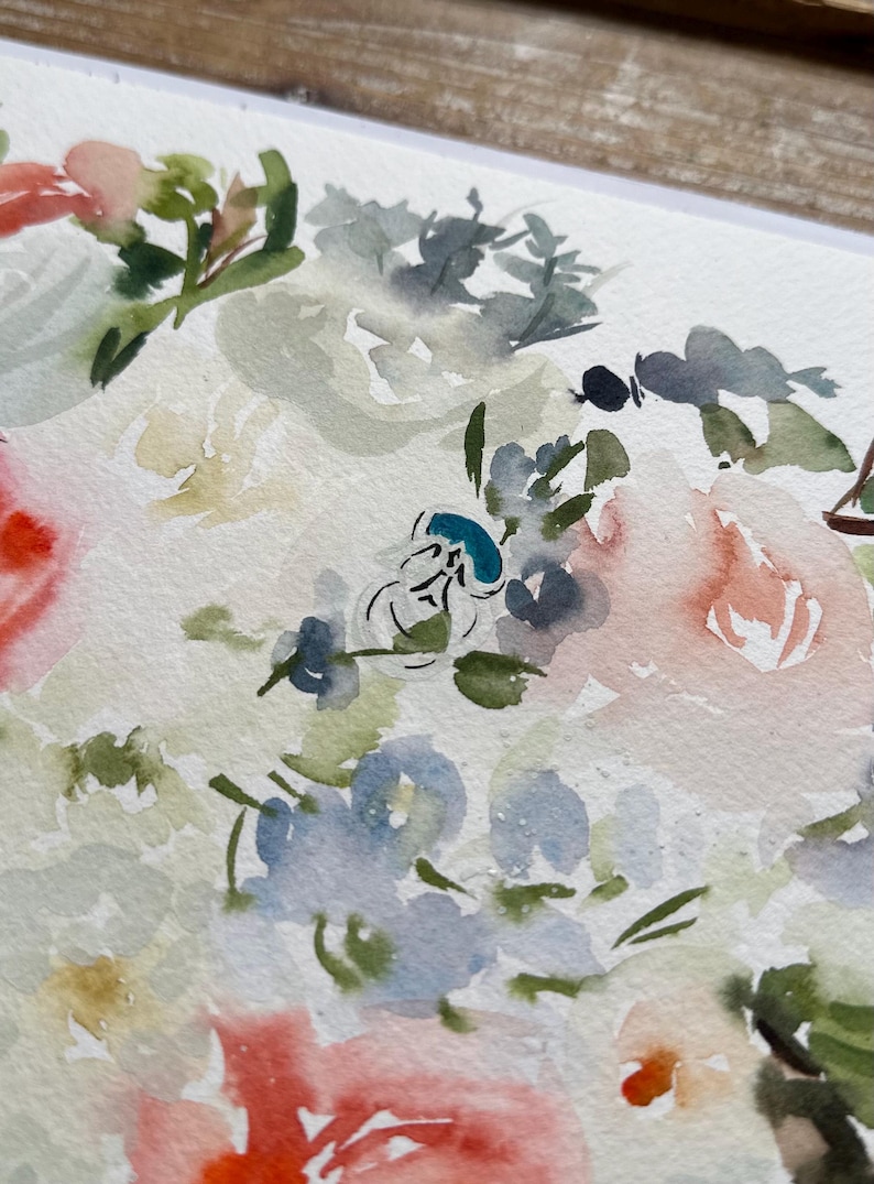 May include: A watercolor painting on textured paper featuring a floral arrangement with soft washes of peach, light blue, sage green, and white. The composition includes loose, blended petals and foliage with a small, distinct teal blue accent.