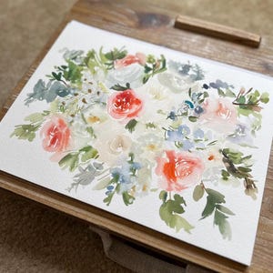 May include: A watercolor painting on white paper featuring a floral arrangement with coral, peach, and white blossoms. The composition includes various green leaves, stems, and small blue accents, rendered with soft, blended brushstrokes.