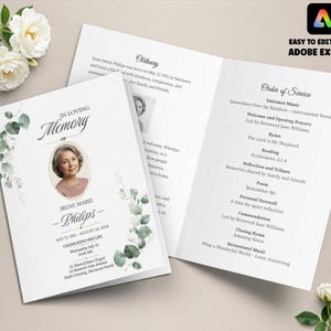 May include: A folded funeral programme template featuring a white background with green eucalyptus leaf illustrations. The front displays the text In Loving Memory of Irene Marie Philips, dates, and a portrait. The inside lists an Order of Service.