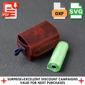 May include: A red leather dog poop bag dispenser with a blue strap and a green plastic bag dispenser. The bag dispenser has a fox logo on the front.
