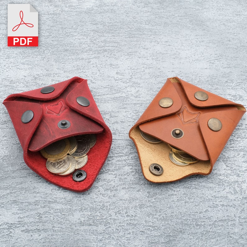 May include: Two leather coin purses, one red and one brown, with a flap closure and snap button. Both purses are open and contain coins.