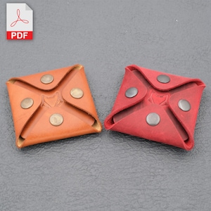 May include: Two leather coin purses, one brown and one red, with a fox logo and snap closures.