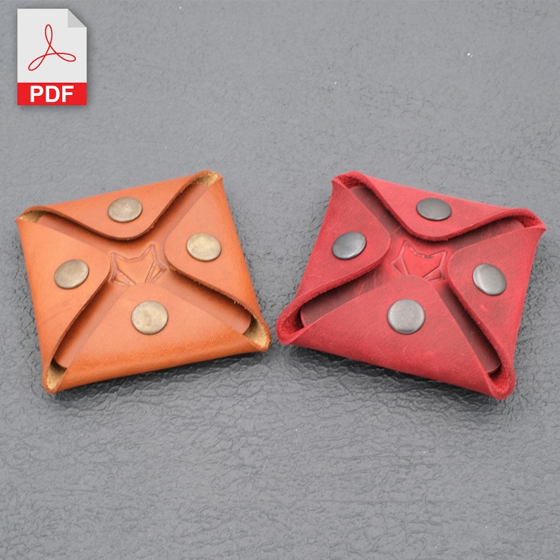 May include: Two leather coin purses, one brown and one red, with a fox logo and snap closures.