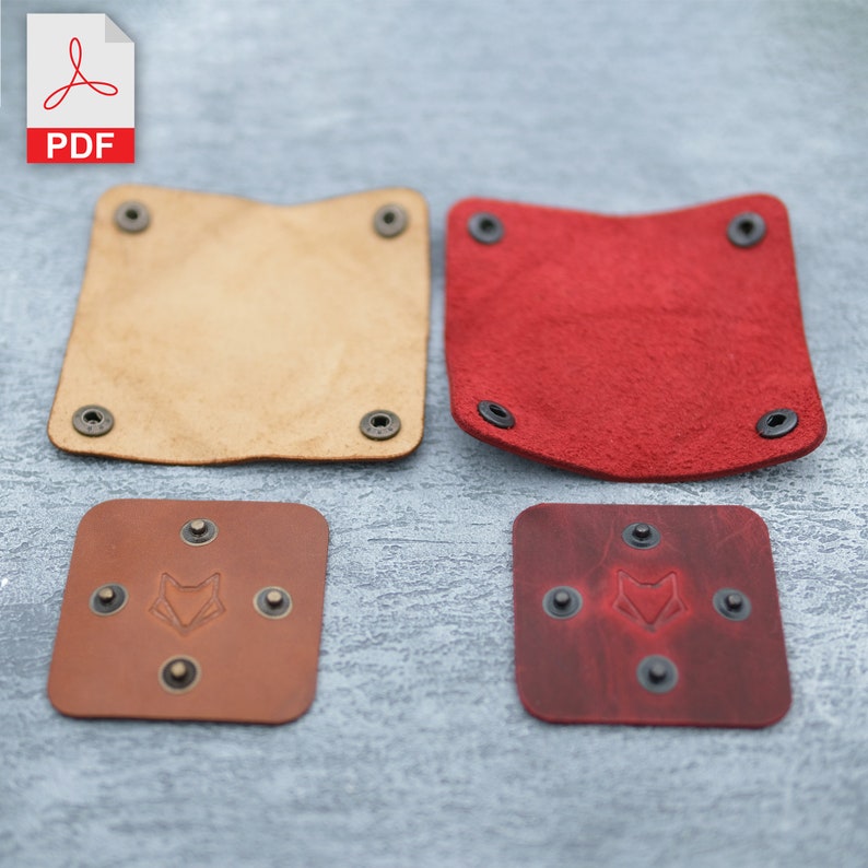 May include: Four leather coasters, two in brown and two in red. The brown coasters have a fox logo embossed in the centre. The red coasters have a fox logo embossed in the centre. All coasters have black metal rivets around the edges.