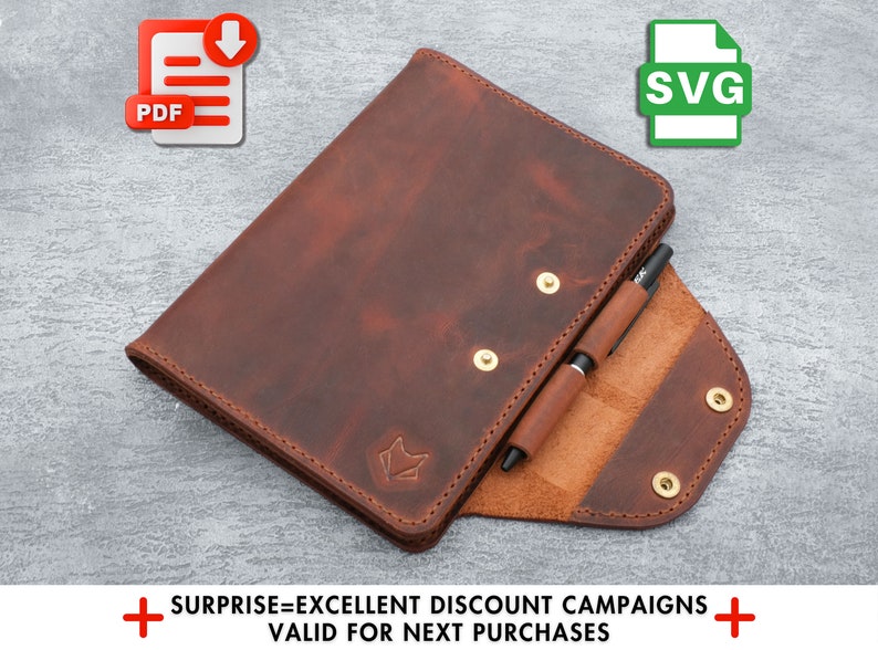 May include: A brown leather notebook with a pen holder and a small fox logo. The notebook is open to reveal a brown leather interior. The notebook is available for download in PDF and SVG formats.
