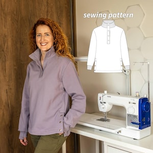 May include: A woman wearing a lavender sweatshirt with a button-up collar and side buttons. The image includes a sewing pattern illustration labeled "sewing pattern" and a white sewing machine.