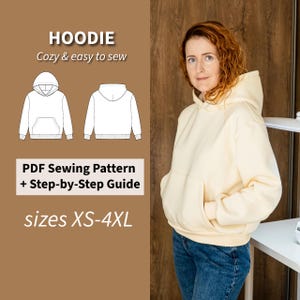 May include: A woman wearing a cream-colored hoodie with a front pocket and hood. The image includes a diagram of a hoodie and text that reads "HOODIE Cozy & easy to sew" and "PDF Sewing Pattern + Step-by-Step Guide sizes XS-4XL."