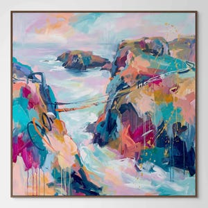 May include: Abstract landscape painting with a square brown frame. The artwork features a colorful coastal scene with cliffs, ocean, and sky. The painting uses a palette of blues, pinks, oranges, and yellows, with visible brushstrokes and paint drips.