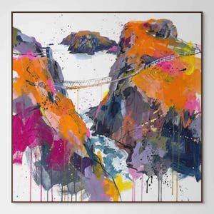 May include: Abstract painting of a coastal landscape with a suspension bridge. The artwork features vibrant colours, including orange, pink, purple, and blue, depicting cliffs, water, and a bridge. The painting is framed in a brown wooden frame.