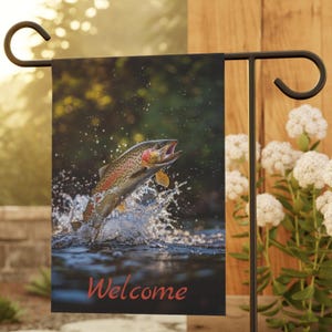 May include: A garden flag with a photo of a trout jumping out of the water. The flag has the word "Welcome" printed on it in red.