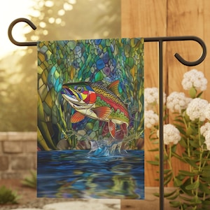 May include: A colorful stained glass style garden flag featuring a trout jumping out of the water. The fish is depicted in shades of green, blue, red, yellow, and orange.
