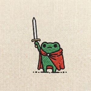 May include: Embroidered patch of a green frog in a red cape, holding a silver sword. The frog has black eyes and is set against a beige backdrop. This whimsical design is ideal for adding to clothing or accessories, a fun and unique item.