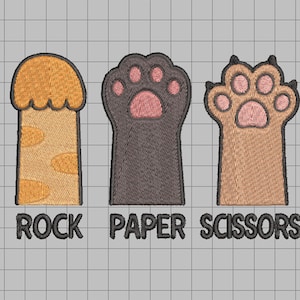 May include: Embroidered design featuring three stylized paw prints representing the game Rock, Paper, Scissors. The text "ROCK PAPER SCISSORS" is embroidered below the images. The paw prints are in shades of orange, brown, and gray.