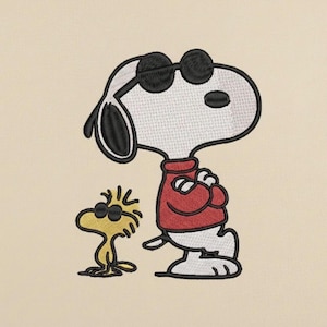May include: Embroidered image of Snoopy and Woodstock wearing sunglasses. Snoopy is in a red sweater, arms crossed. Woodstock is yellow. The background is a light beige color.