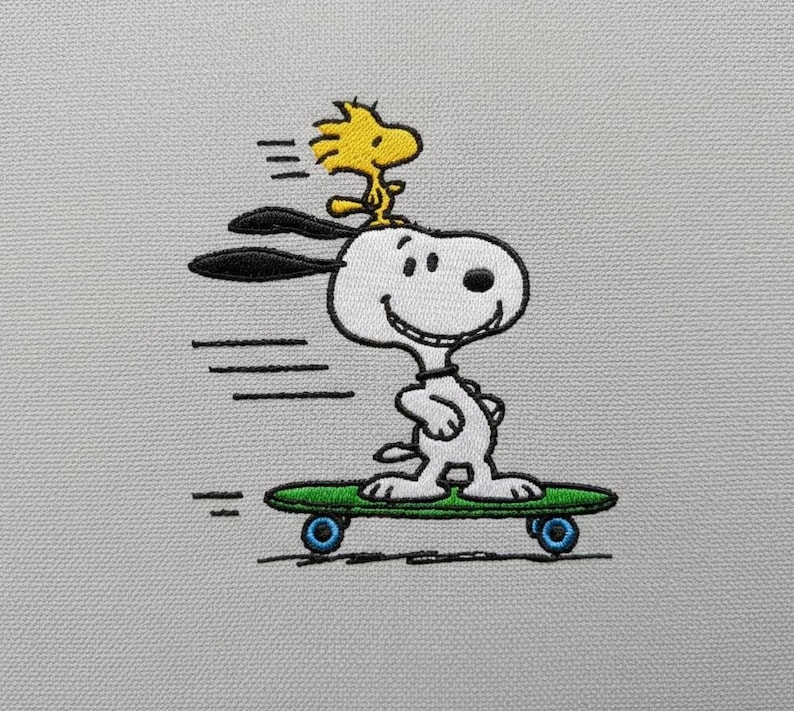 May include: Embroidered image of Snoopy skateboarding with Woodstock on his head. Snoopy is white with black ears and a black nose, riding a green skateboard with blue wheels. Woodstock is yellow. The image is on a light gray background.