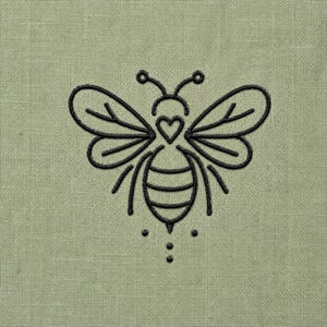 May include: A sage green fabric featuring a black embroidered line art design of a bee. The bee has a heart-shaped thorax, two sets of wings with vein details, and a striped abdomen. Three small dots are positioned below the bee's stinger.