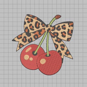 May include: Embroidered design of two red cherries with green stems and a leopard print bow. The cherries have small white highlights. The bow has a tan background with brown spots.