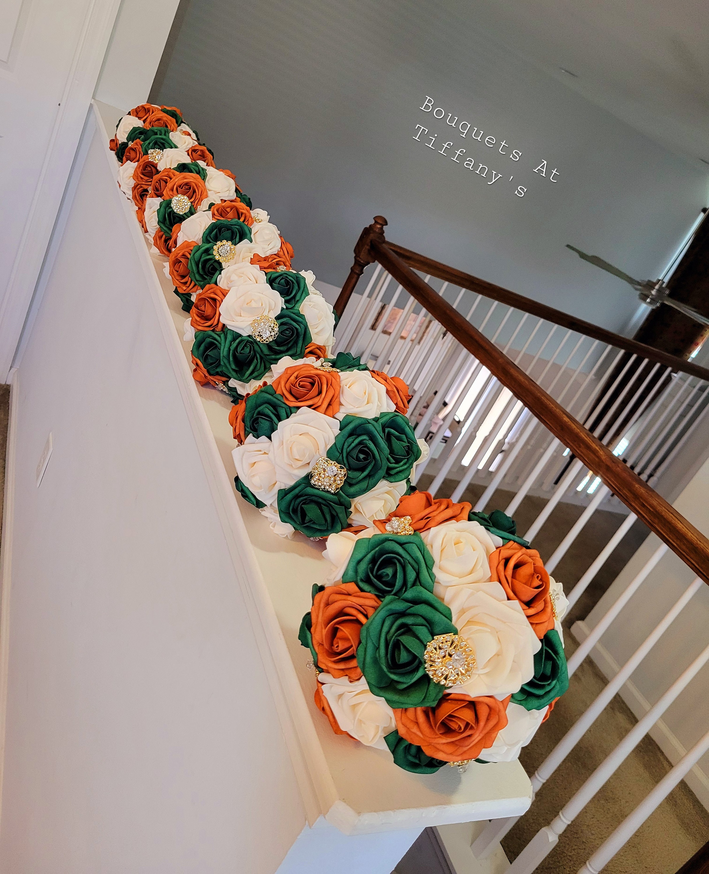 Bridesmaids 8" brooch Bouquets with burnt orange, hunter green, and cream flowers. Gold brooches and gold bling handle