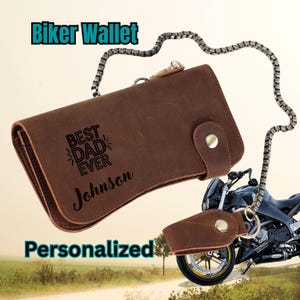 May include: A brown leather biker wallet with the text "Best Dad Ever" and the name "Johnson". The wallet has a chain and a matching key fob. The words "Biker Wallet" and "Personalized" are also displayed.