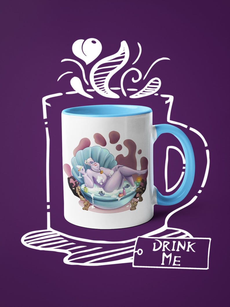 May include: White ceramic mug with a blue interior and handle. The mug features a cartoon illustration of a purple character in a seashell bathtub. The words "DRINK ME" are printed on a tag. The mug is set against a purple background.