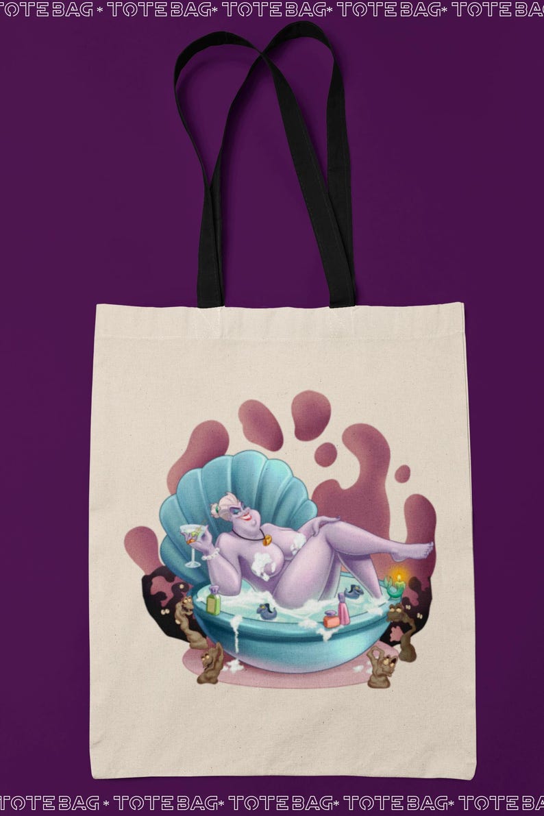 May include: Cream-colored tote bag featuring a cartoon illustration of a purple character lounging in a seashell-shaped tub. The character is holding a cocktail. The bag has black handles and a purple background.