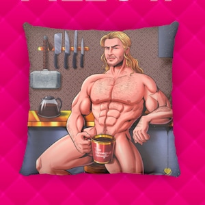 May include: Decorative pillow featuring a muscular cartoon figure with long blonde hair, holding a coffee mug that reads "The Strongest Avenger." The background includes kitchen knives, a coffee pot, and a hammer. The pillow is set against a pink background with the word "PILLOW" in white.