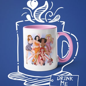 May include: White ceramic mug with a pink rim and handle. The mug features a colorful illustration of five women with a 'Drink Me' tag attached to the handle.